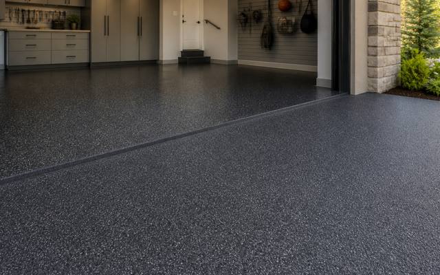 Two-car garage with a car parked on a finished charcoal rubber floor